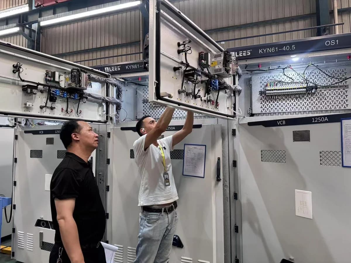 Inspector checking electrical switchgear before shipment at a Chinese factory